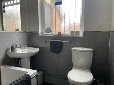 a bathroom with a white toilet and a sink at The Clifton Guest House in Liverpool