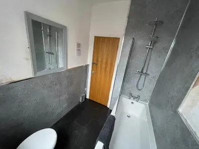 a bathroom with a toilet and a shower and a sink at The Clifton Guest House in Liverpool