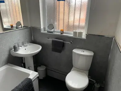 a bathroom with a white toilet and a sink at The Clifton Guest House in Liverpool