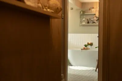 a bathroom with a tub and a toilet and a sink at Heather room at field view cottage in Eccleston