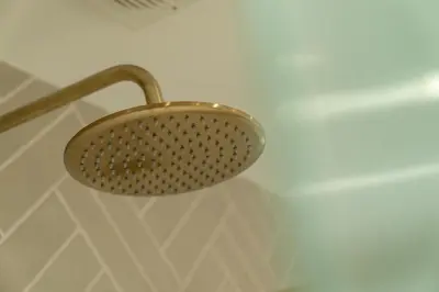 a shower light hanging from a wall in a bathroom at Heather room at field view cottage in Eccleston