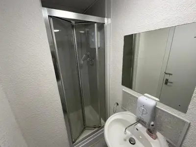 a bathroom with a shower and a sink at North Coast Hotel in Blackpool