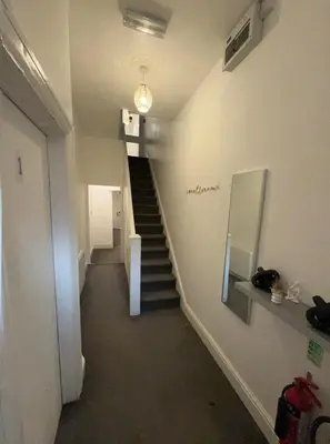 a hallway with a staircase in a building at North Coast Hotel in Blackpool