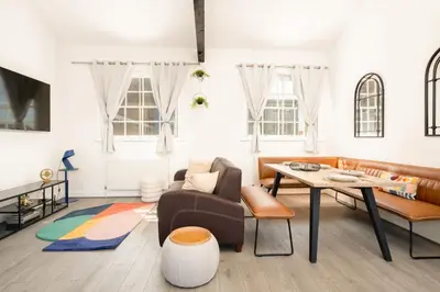 a living room with a couch and a table at Stylish Prime Location Apartment by VICHY in Liverpool