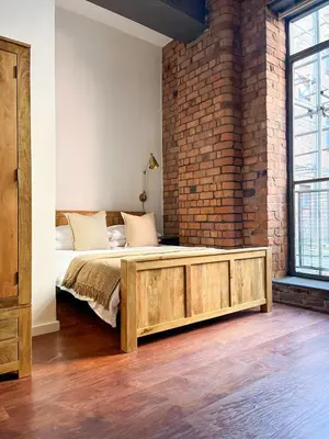 a bedroom with a bed and a brick wall at Stylish Loft Apartament - City Center L1 in Liverpool