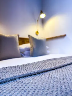 a bedroom with a bed with pillows and a lamp at Stylish Loft Apartament - City Center L1 in Liverpool