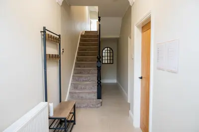a hallway with stairs in a house at Casa Arkles - next to stadium - free parking in Liverpool