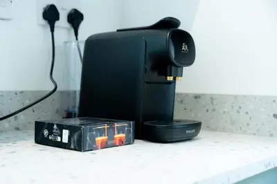 a coffee maker sitting on a counter next to a box at Casa Arkles - next to stadium - free parking in Liverpool