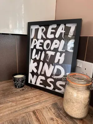a table with a jar and a picture on it at Everythings Cosy at Clucas in Ormskirk