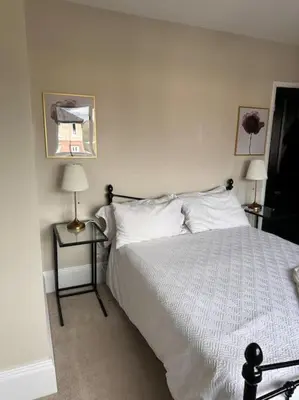 a bedroom with a white bed and two lamps at Everythings Cosy at Clucas in Ormskirk