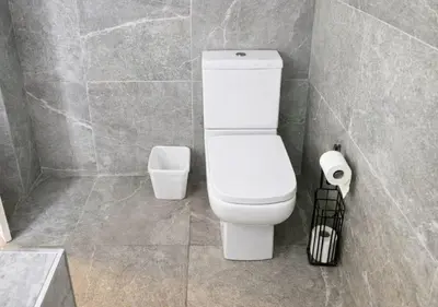 a bathroom with a toilet and a trash can at Williamson 2 Bedroom City Centre sleeps 10 in Liverpool
