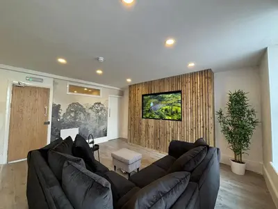 a living room with a large couch and a wall at Williamson 2 Bedroom City Centre sleeps 10 in Liverpool