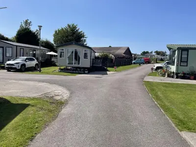 a road leading to a house with a caravan at The Thimble static Holiday Home in Lancaster