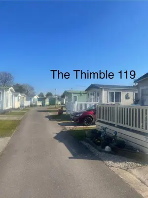 a street with a row of houses with the phrase the thrumble at The Thimble static Holiday Home in Lancaster