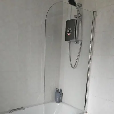 a shower with a shower head in a bathroom at Open planned apartment in Birkenhead