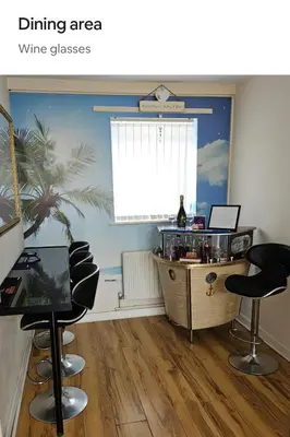 a dining area with a table and some chairs at Open planned apartment in Birkenhead