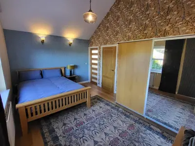 a bedroom with a bed in a room with a window at Anchor Gardens Villa in Lindal in Furness
