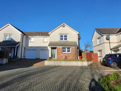 a house with a car parked in a driveway at Anchor Gardens Villa in Lindal in Furness