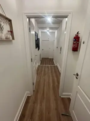 a hallway with white walls and a wood floor at New Luxury apartment, sea viewWith parking in Blackpool