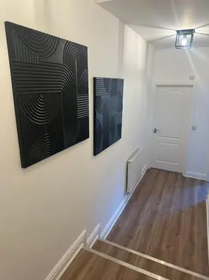 two paintings hanging on a wall in a hallway at New Luxury apartment, sea viewWith parking in Blackpool