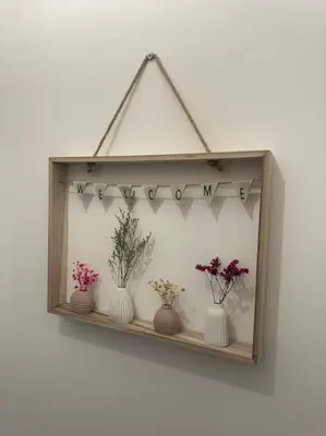a wooden shelf with vases of flowers on a wall at New Luxury apartment, sea viewWith parking in Blackpool