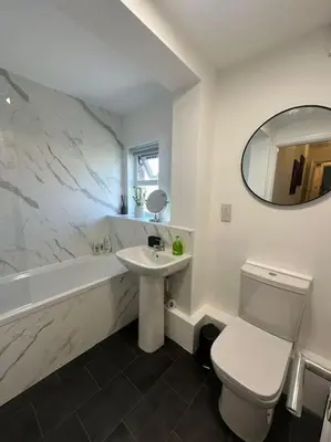 a white bathroom with a sink and a toilet and a tub at New Luxury apartment, sea viewWith parking in Blackpool