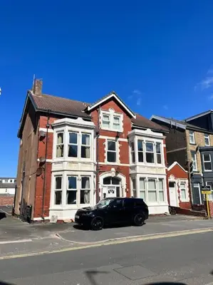 a black car parked in front of a brick building at New Luxury apartment, sea viewWith parking in Blackpool