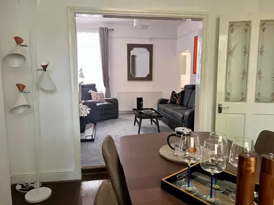 a living room with a table with wine glasses on it at Spacious Home - Sleeps 5 persons - Minutes Walk from Anfield Stadium in Liverpool