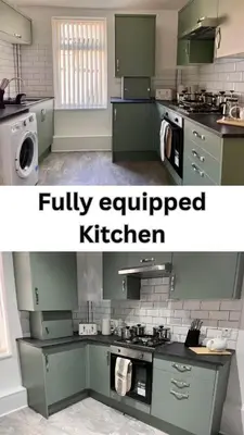 a kitchen with green cabinets and a washer and dryer at Spacious Home - Sleeps 5 persons - Minutes Walk from Anfield Stadium in Liverpool
