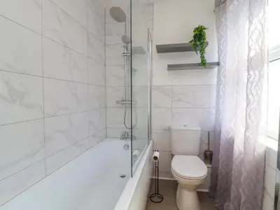 a white bathroom with a toilet and a shower at 49 Waddington Road in Clitheroe
