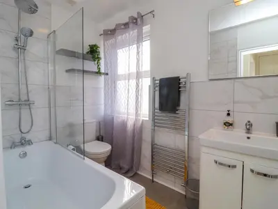 a bathroom with a tub and a toilet and a sink at 49 Waddington Road in Clitheroe