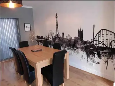 a dining room with a wooden table and chairs at Seaside Suites in Blackpool