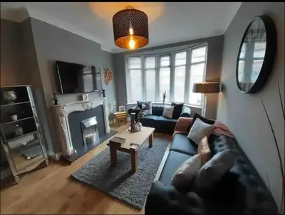 a living room with a couch and a fireplace at Seaside Suites in Blackpool