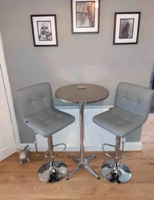 two chairs and a table and a table and chairs at Seaside Suites in Blackpool