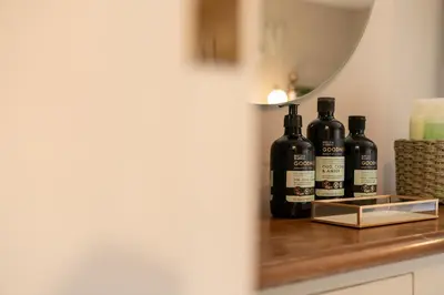 a group of bottles of wine sitting on a counter at Fern room at field view cottage in Eccleston