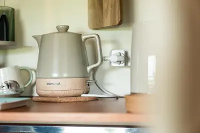 a tea kettle sitting on top of a kitchen counter at Fern room at field view cottage in Eccleston