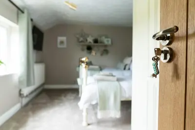 an open door to a bedroom with a bed at Fern room at field view cottage in Eccleston