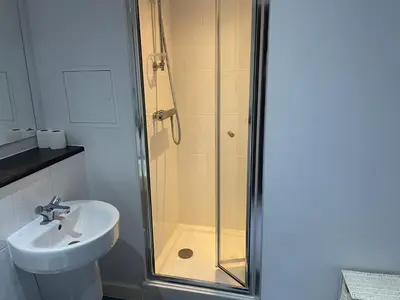 a bathroom with a shower and a sink at Radio City Apartments City Centre sleeps 4 in Liverpool