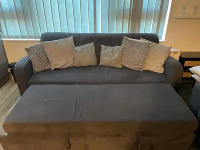 a couch with pillows on it with a coffee table at Radio City Apartments City Centre sleeps 4 in Liverpool