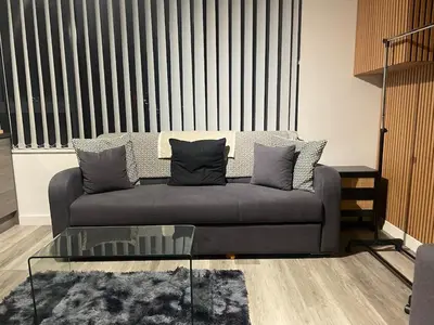 a living room with a couch and a glass table at Radio City Apartments City Centre sleeps 4 in Liverpool