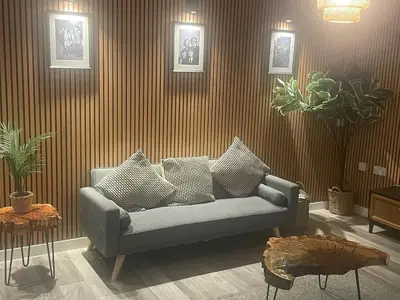 a living room with a couch with pillows at Manhattan Apartment City Centre sleeps 4 in Liverpool
