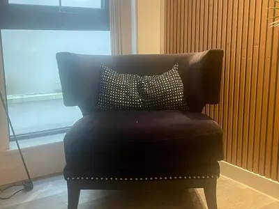 a black chair with a pillow on top of it at Manhattan Apartment City Centre sleeps 4 in Liverpool