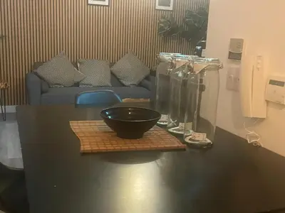 a table with a bowl and two glass vases on it at Manhattan Apartment City Centre sleeps 4 in Liverpool