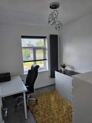 an office with a desk and a chair and a window at Woolfall heath avenue in Roby