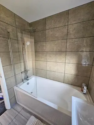 a bathroom with a tub and a shower at Woolfall heath avenue in Roby