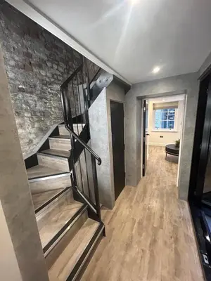 a staircase in a room with a brick wall at 10 Hockenhall - Liverpool's Oldest House in Liverpool