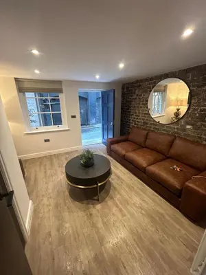 a living room with a couch and a table at 10 Hockenhall - Liverpool's Oldest House in Liverpool