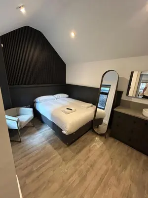 a bedroom with a large bed and a mirror at 10 Hockenhall - Liverpool's Oldest House in Liverpool