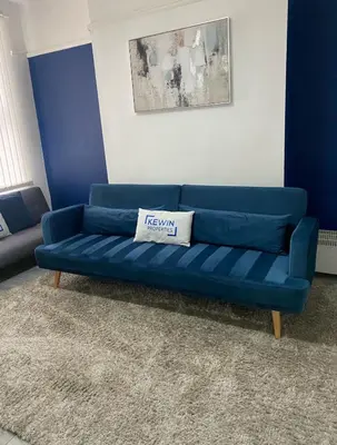 a blue couch sitting in a living room at No 6 - Home away from Home in Liverpool