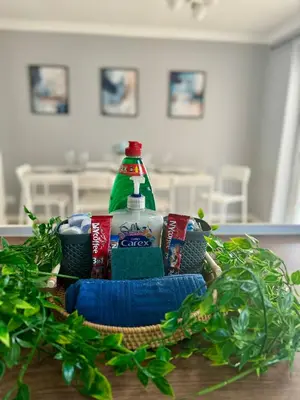 a basket of food and drinks on a table at Stunning Open Plan 3 Bed House - Driveway & Garden in Litherland